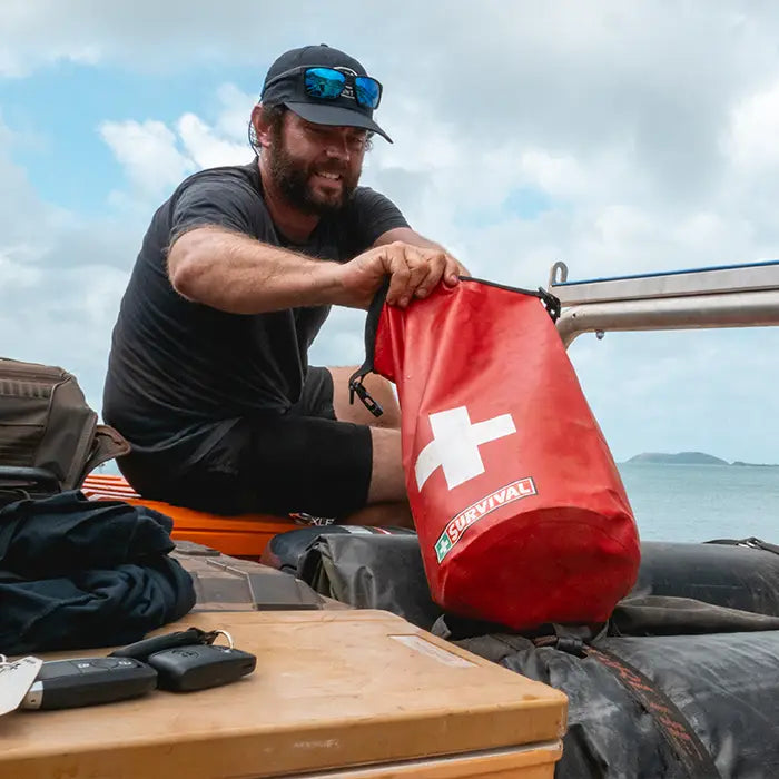 Man looking through his first aid kit waterproof dry bag